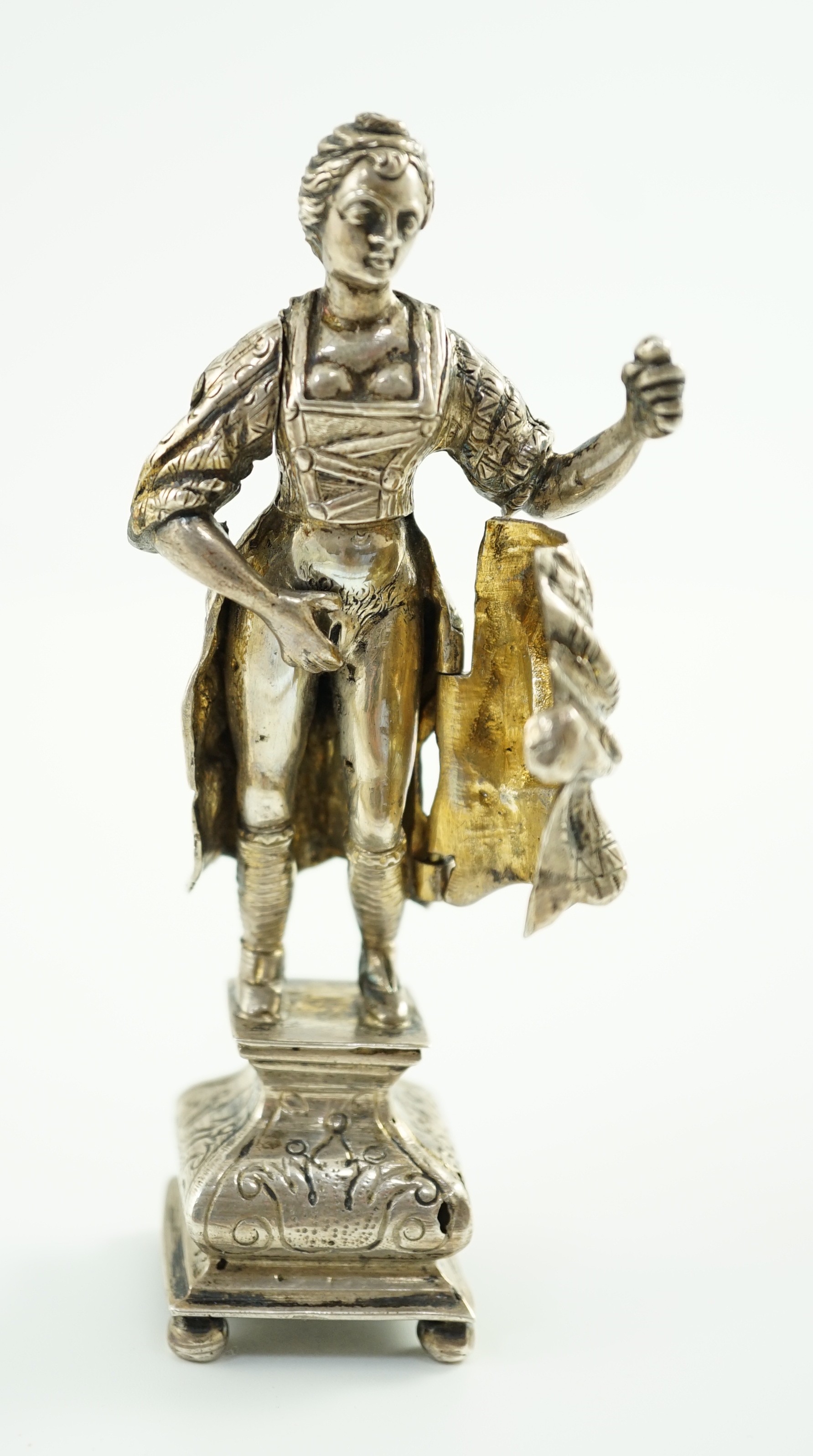A late 19th century Dutch silver erotic miniature figure of a lady, on a square base with ball feet